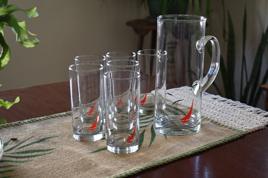 Glass pitcher and 6 matching tumblers with a nautical sailboat design.