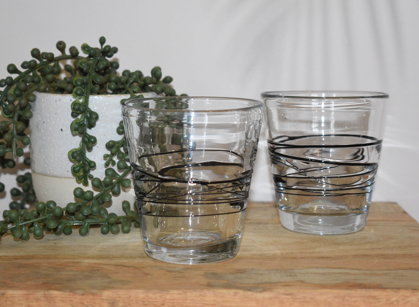 Uzu Clear and black fused handblown lowball glasses. Set of 2