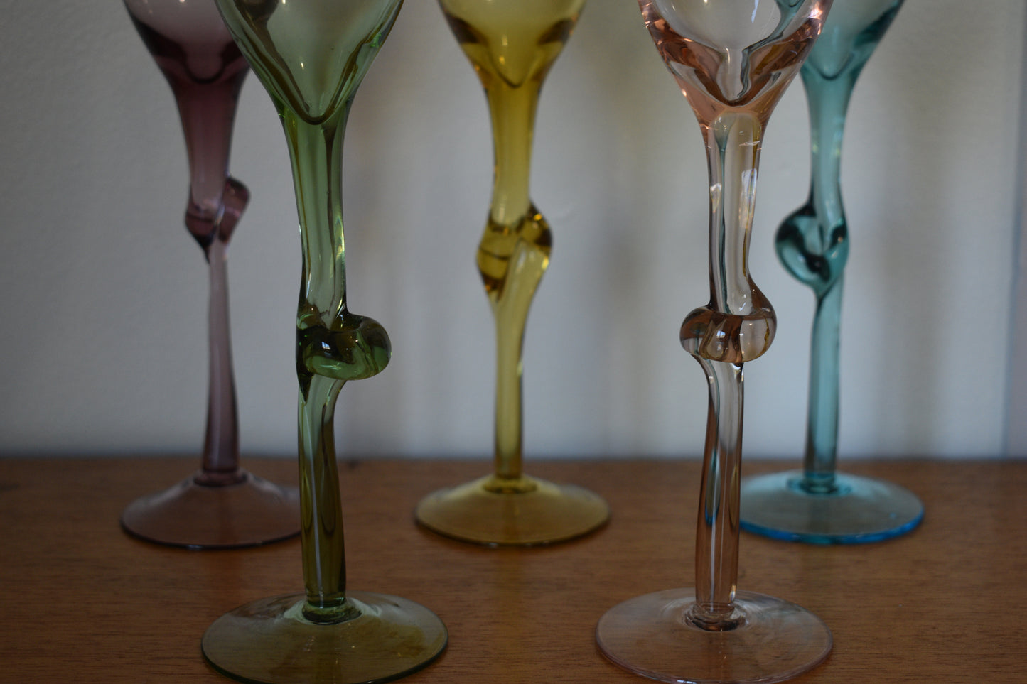 Set of 5 Harlequin coloured Champagne flutes with knotted stems