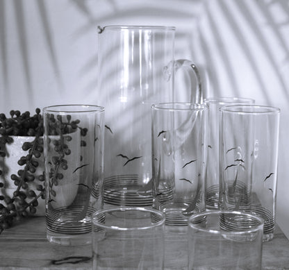 Glass pitcher and 6 matching tumblers with a nautical sailboat design.