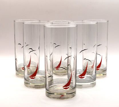 Glass pitcher and 6 matching tumblers with a nautical sailboat design.
