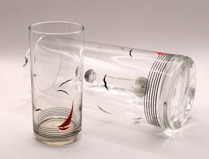 Glass pitcher and 6 matching tumblers with a nautical sailboat design.
