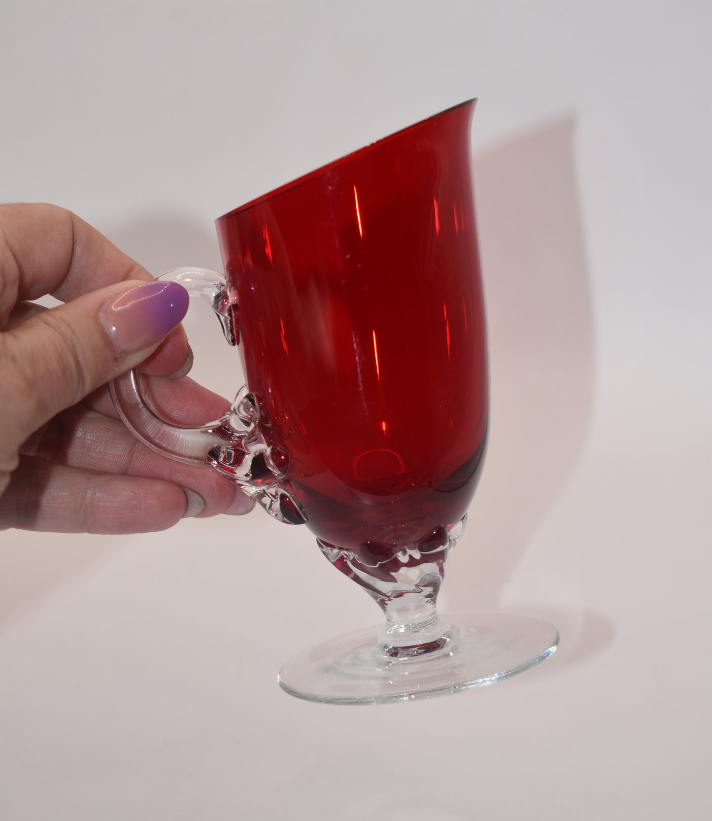 Vintage Ruby Red jug with clear claw stem and handle.